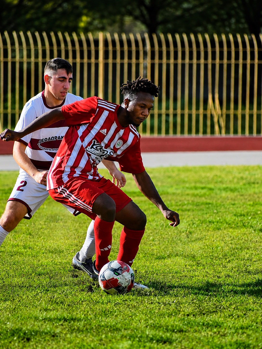 Barney Kirimi driving forward with the ball for Olympiakos Zacharos